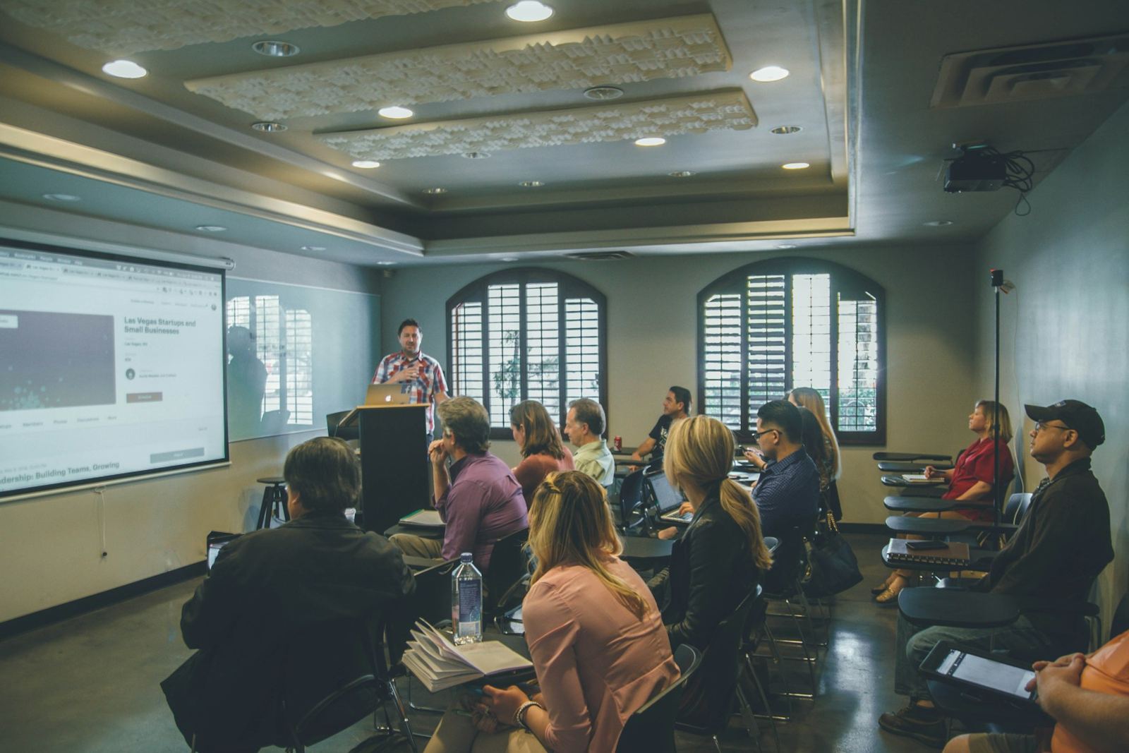 Adults in a classroom listening to an instructor